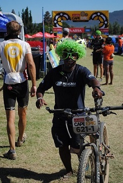 One of the volunteers of the Exxaro Academy taking a bike from the finish line to be washed. Photo: Supplied