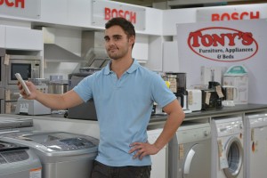 Matthew De La Mare, co-owner of Tony's Furniture, Appliances & Beds, gives participants a glimpse of some of the lucky draw prizes on offer at The Herald VW Cycle Tour, which takes place over the first weekend in February. One expo visitor will also win a La-Z-Boy recliner by taking a "selfie" at the Tony's display at The Boardwalk Convention Centre. Photo: Full Stop Communications
