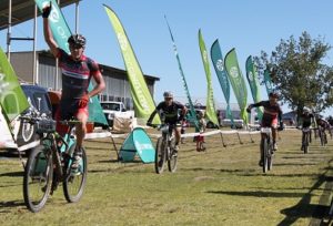 EAI Cycling's Johann Rabie celebrates the win on stage two of the nine-day Old Mutual joBerg2c in Reitz on Saturday. He is chased by Cannondale-Blend's Darren Lill (left) and EAI teammate Gawie Combrinck. Photo: Full Stop Communications