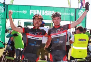 EAI Cycling's Gawie Combrinck (left) and Johann Rabie celebrate their victory in the nine-day Old Mutual joBerg2c mountain bike race, which finished at Scottburgh, KwaZulu-Natal, on Saturday. Photo: Full Stop Communications