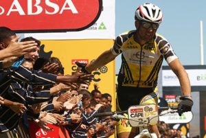 Christoph Sauser of Investec-Songo-Specialized celebrates with the HTS Drostdy school Learners after winning stage 3 with partner Jaroslav Kulhavy of Investec-Songo-Specialized during stage 3 of the 2015 Absa Cape Epic Mountain Bike stage race held from Oak Valley Wine Estate in Elgin to HTS Drostdy in Worcester, South Africa on the 18 March 2015 Photo by Shaun Roy/Cape Epic/SPORTZPICS