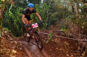 The muddied South African sub-veteran marathon champion Henry Uys en route to victory in the Pennypinchers Silverstar MTB Challenge in Krugersdorp on Saturday. Photo: Jetline Action Photo