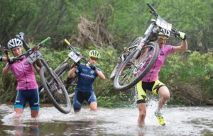 Esther Suss (right) and Catherine Williamson of Sasol Racing lead Robyn de Groot of Ascendis Health across a river early on during Stage 3 of the Cape Pioneer Trek from Oudtshoorn to De Rust, South Africa on Wednesday. Photo credit: Zoon Cronje/Nikon