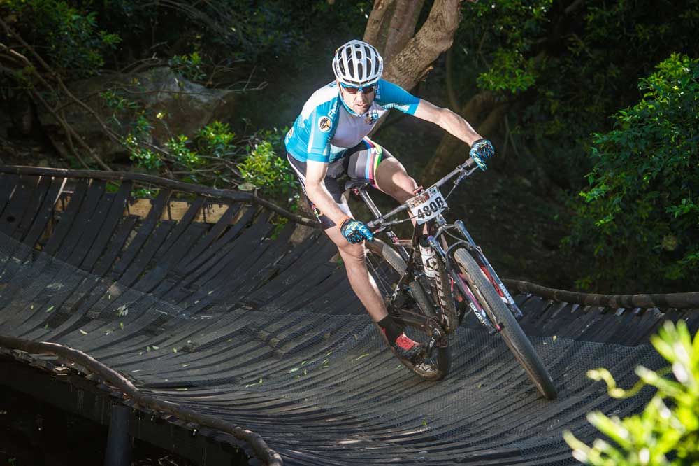 Swiss mountain biking stars Christoph Sauser and Konny Looser will team up one more time to defend their title at the 7th annual FNB Wines2Whales Mountain Bike (MTB) Race that will start at the picturesque Lourensford Wine Estate (Somerset West) on Friday, 06 November 2015. Seen here: Christoph Sauser in action during the 2014 FNB Wines2Whales MTB Race. Photo Credit: Volume Photography