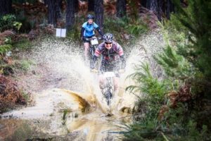 A rider crossing a river during day two of the Glacier Storms River Traverse. Photo by: Oakpics.com / Dryland Event Management / SPORTZPICS