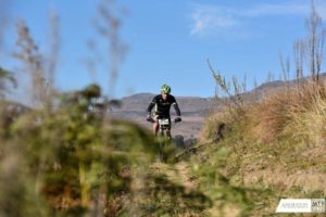 A single participant crests a climb at the National MTB Series