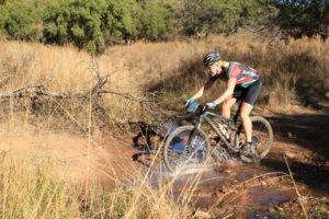 A rider going through a puddle at the Waterberg MTB Encounter