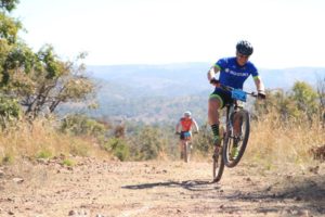 An energetic rider pops a wheelie at the Waterberg MTB Encounter