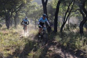 A team passes through a wooded area at the Waterberg MTB Encounter