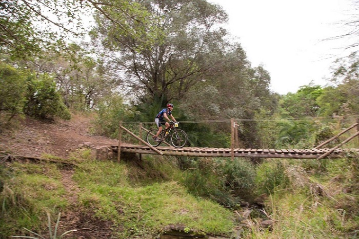 A mountain biker crossing a bridge during last year's Swazi 3 Reserves.