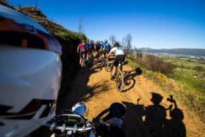 A motorbike rider's view of the mountain bikers on day one of the Varsity MTB Challenge just outside of Paarl.