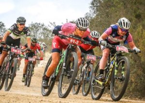 Team Team Spur Valencia's Ariane Luthi (pink) and Amy McDougall lead Dimension Data's Louis Visser in a downhill charge on day three of the Cape Pioneer Trek.
