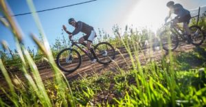 A rider greets the cameraman during stage one of the Wines2Whales Adventure. Photo: Tobias Ginsberg