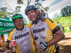 An image of two riders enjoying the delicious treats on offer at one of the waterpoints on stage two of Wines2Whales Race.