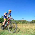 A mountain biker enjoyed some beautiful green pastures along the Trailseeker route.