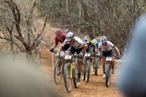 The leading men pushing hard up a climb in the early stages of the elite men's race at the UCI Mountain Bike World Cup in Stellenbosch. Photo: Shannon Valstar