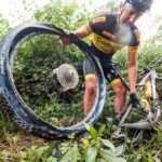 Rider fixing a mechanical during the sani2c Race. Photo: Anthony Grote