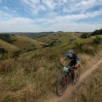 A mountain biker enjoys beautiful scenery on day three of sani2c Adventure