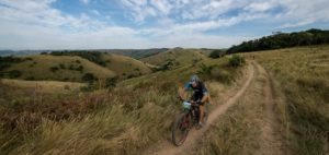A mountain biker enjoys beautiful scenery on day three of sani2c Adventure