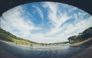 A fisheye view of a rider crossing a bridge on day three of sani2c Adventure