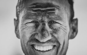 A close-up of a rider's dirty face after day one of sani2c Adventure