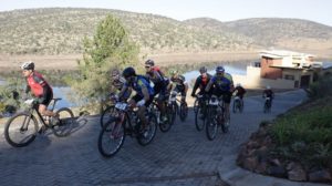 A group of riders labouring up a paved climb during stage three of the Waterberg MTB Encounter. Photo: Gerrie Kriel / Twin Productions SA