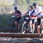 Leading riders carrying their bikes across a train track during stage three of the Waterberg MTB Encounter. Photo: Gerrie Kriel / Twin Productions SA