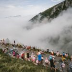 Fans cheer as riders pass them during stage 19 of the Tour de France