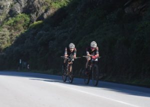 Riders taking on a flat road section next to a hillside during the Storms River Traverse. Photo: ZCMC