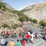 A group of cyclists take a corner during a Vuelta a Espana stage.