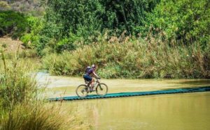 A rider crossing a suspension bridge on the Tugela River during stage two of the Berg and Bush 'Descent'. Photo: Tobias Ginsberg