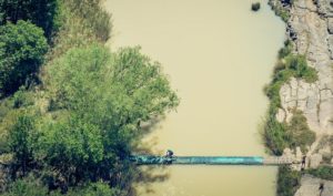 An aerial view of a rider crossing the suspension bridge across the Tugela River. Photo: Em Gatland