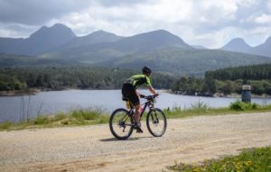 A rider spoiled with a splendid view of a lake and the mountains during stage three of the Cape Pioneer Trek. Photo: Carli Smith