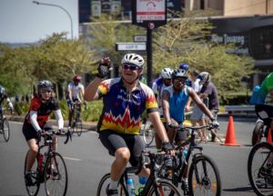 A rider waving to supporters during the 947 Cycle Challenge. Photo: 947 Cycle Challenge