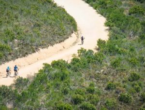 A wonderful aerial shot of riders moving along a wide and open gravel section at the Origin of Trails. Photo: David Tarpey
