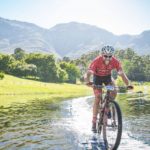 A rider enjoying the suspension bridge across the river at the Origin of Trails. Photo: David Tarpey
