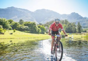 A rider enjoying the suspension bridge across the river at the Origin of Trails. Photo: David Tarpey