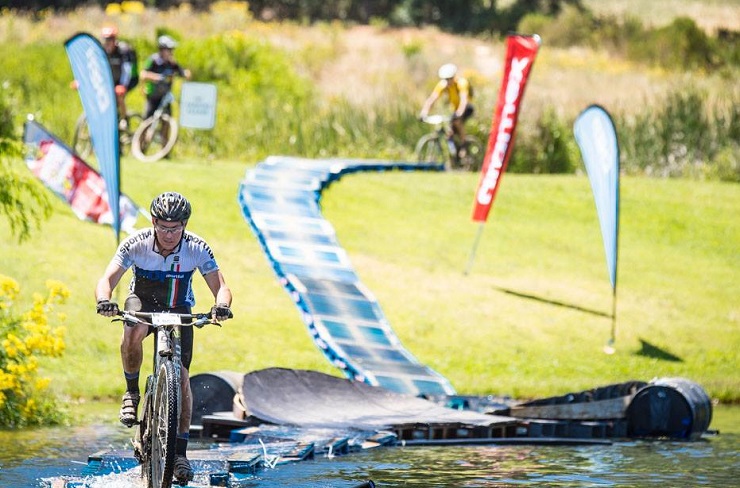 A rider crossing a suspension bridge across a river during the Origin of Trails yesterday. Photo: David Tarpey/Stillwater Sports