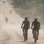 Riders moving along a dusty gravel road during the Desert Dash. Photo: Gondwana Collection Namibia