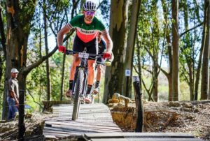 Cooking TV personality Jan Braai moving over a wooden bridge at the TransCape MTB Encounter. Photo: Jacques Marais