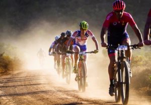 Riders leaving a cloud of dust behind them on a gravel section at the TransCape MTB Encounter. Photo: Jacques Marais