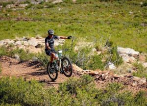 A rider performing a wheelie during the TransCape MTB Encounter. Photo: Jacques Marais