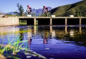 Riders moving across a bridge on the river during the TransCape MTB Encounter. Photo: Jacques Marais