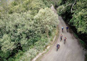 An aerial shot of riders moving along a bend and down a slight descent during the TransCape MTB Encounter. Photo: Jacques Marais
