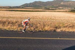A rider soloing along a road moving through the countryside during stage two of the Tour of Good Hope. Photo: Henk Neuhoff Photography